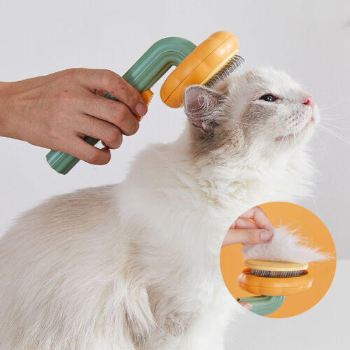 Pet grooming brush being used on a cat, with orange pin head and green handle