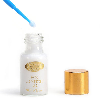 Lash lifting kit fix lotion bottle with blue applicator tip and gold cap