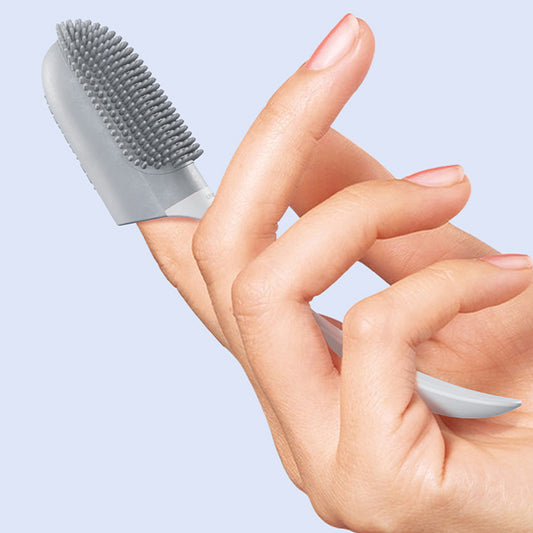 Silicone finger toothbrush with gray bristle pad on finger