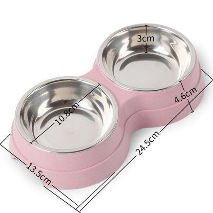 Double pet bowl with two stainless steel dishes on pink base, 24.5cm long, 13cm wide