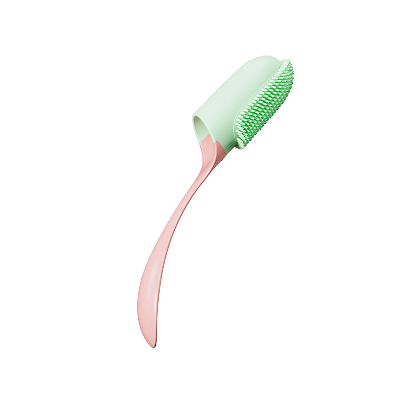 Silicone finger toothbrush with green bristles on pink finger cap