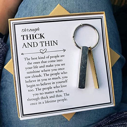 Keychain with metal keyring on a greeting card showing the quote “THICK AND THIN”.