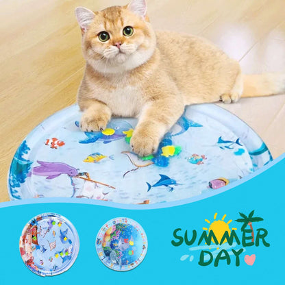 Inflatable round pet cooling water mat with ocean animal print, resting under a cat